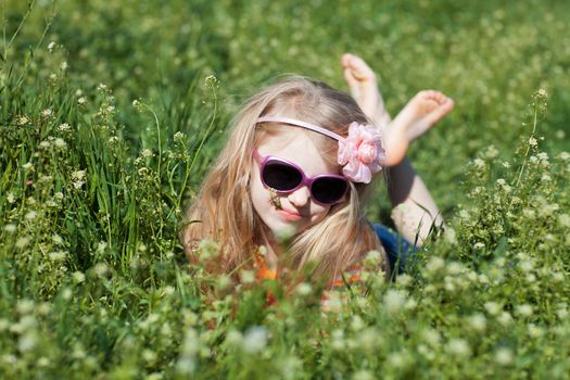 small barefooted girl in grass