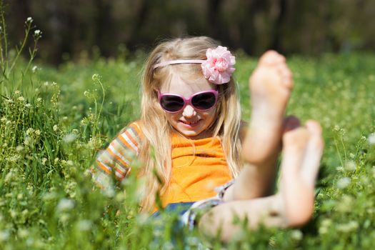 small barefooted girl in grass