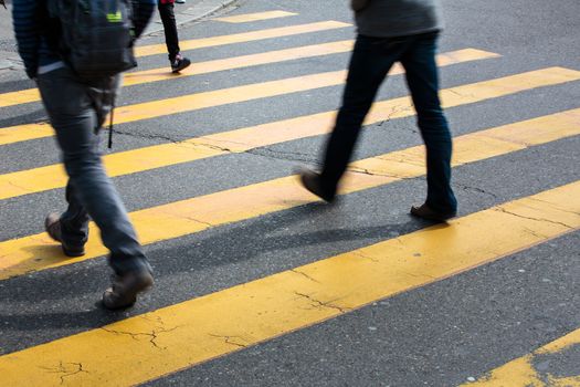 urban traffic concept - city street with a motion blurred crowd crossing a road