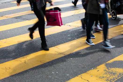 urban traffic concept - city street with a motion blurred crowd crossing a road