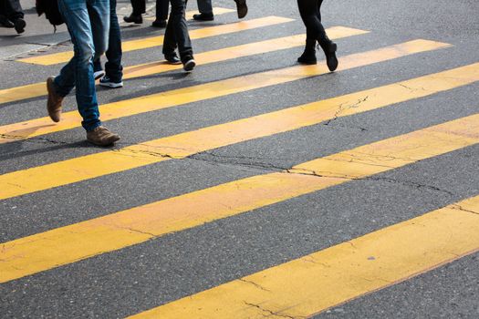 urban traffic concept - city street with a motion blurred crowd crossing a road