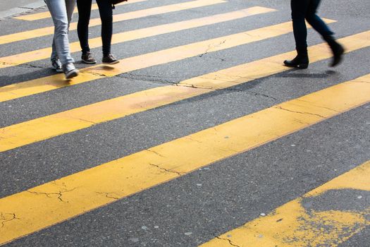 urban traffic concept - city street with a motion blurred crowd crossing a road