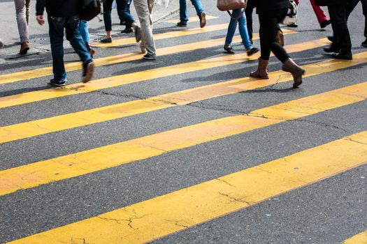 urban traffic concept - city street with a motion blurred crowd crossing a road