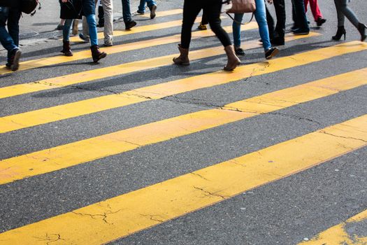 urban traffic concept - city street with a motion blurred crowd crossing a road