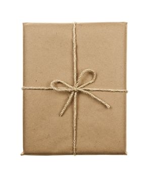 Gift package in brown paper wrapper tied with twine isolated on white background