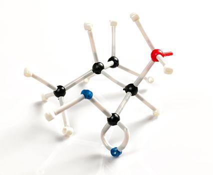 Structure of amino acid valine molecule represented with molecular model building kit