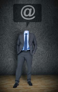 Composite image of headless businessman with at sign in speech bubble in grey room