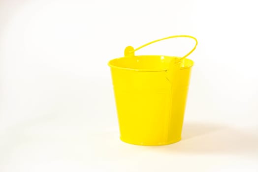 yellow bucket on white scene,shallow focus