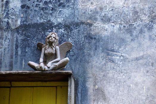 angel sculpture at the corner of garden