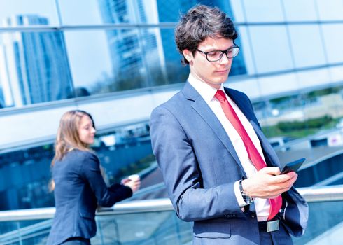 Junior executive dynamic phoning outside of his office