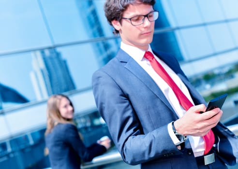 Junior executive dynamic phoning outside of his office