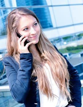 Junior executive dynamic phoning outside of her office