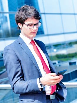 Junior executive dynamic phoning outside of his office