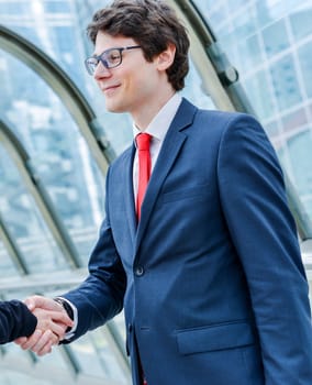 Junior executives dynamics shaking hands