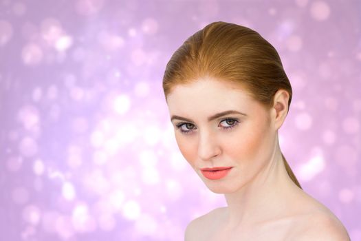 Beautiful redhead looking at camera against purple abstract light spot design