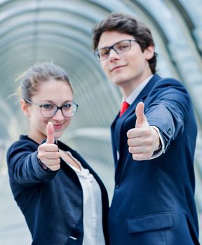 expressive portrait of junior executives of company thumb up