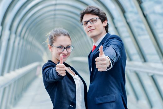 expressive portrait of junior executives of company thumb up