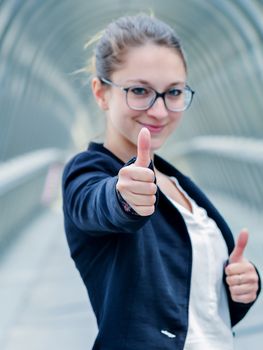 expressive portrait of junior executives of company thumb up