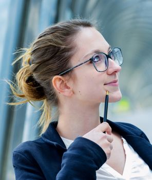 Outdoor portrait of a dynamic junior executive thinking