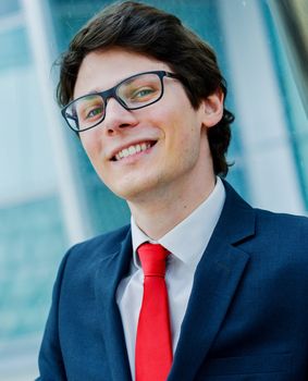 Outdoor portrait of a dynamic junior executive smiling