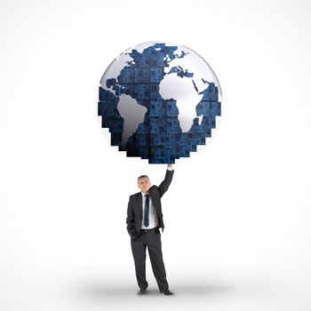 Composite image of businessman holding blue earth against white background with vignette