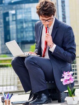 Junior executive dynamic working outside of his office