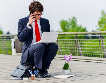 Junior executive dynamic working outside of his office