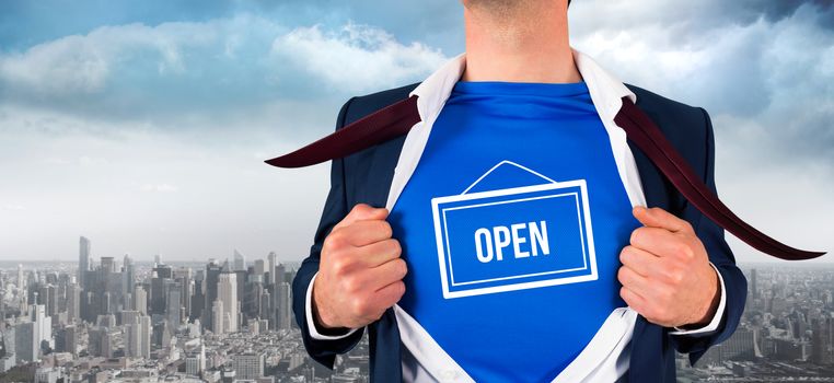 Businessman opening his shirt superhero style against balcony overlooking city