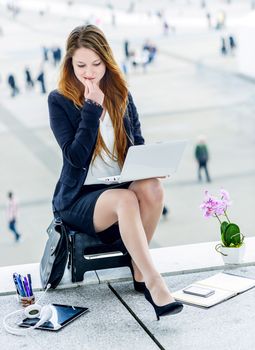 Stressed junior executive dynamic working outside of her office