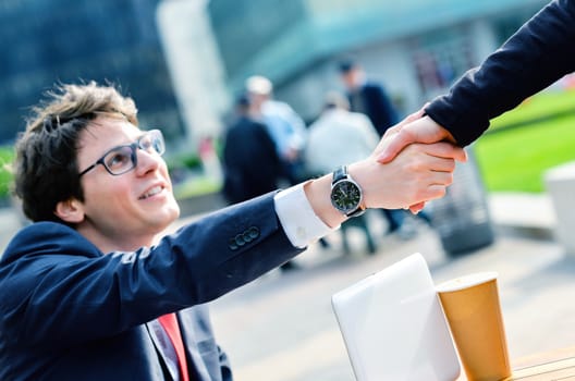 Junior executives dynamics shaking hands