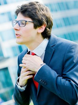 Outdoor portrait of a dynamic junior executive smiling