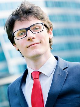 Outdoor portrait of a dynamic junior executive smiling