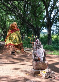 Old ant-hill converted into shrine for Manasa, the snake-goddess. The man with the trident is known as ���Karuppannaswamy.��� He is a demi-god servant of Manasa and the protector of the shrine.
