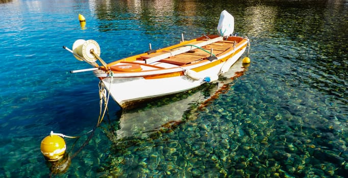 Old boat in blue green sea water