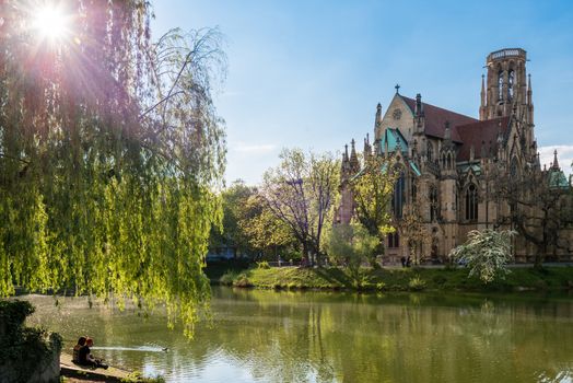 STUTTGART, GERMANY - APRIL 24, 2014: People are enjoying a great sunny spring day around Johanneskirche (St. Johns Church) at Feuersee (fire pond) on April, 24,2014 in Stuttgart, Germany.