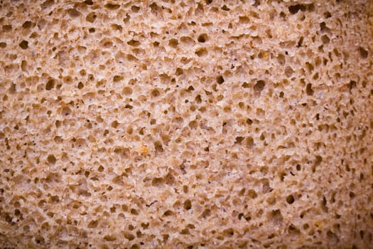 rye bread porous. textured surface is a piece of bread. macro