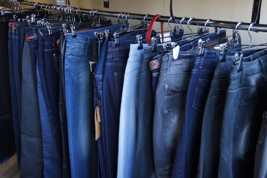 jeans hung on hangers in store for sale