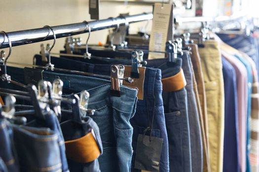 jeans hung on hangers in store for sale