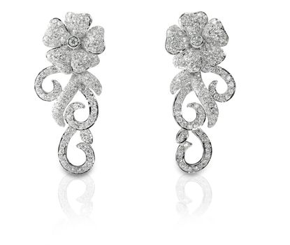 Beautiful floral shaped Diamond pave earrings isolated on white with a reflection