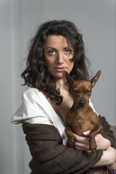 woman is holding her dog