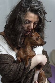 woman is holding her dog