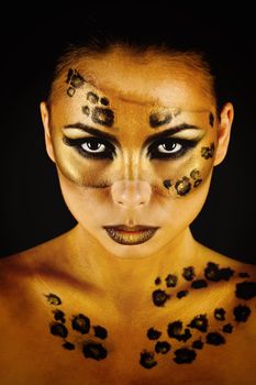 Attractive young girl with makeup wild leopard close-up portrait