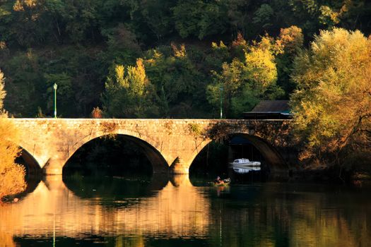 Arched bridge reflected in Crnojevica river, Montenegro, Balkans