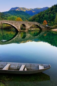 Arched bridge reflected in Crnojevica river, Montenegro, Balkans