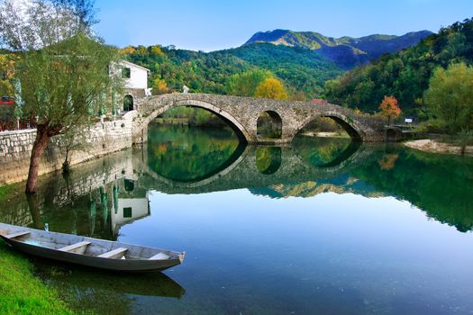 Arched bridge reflected in Crnojevica river, Montenegro, Balkans