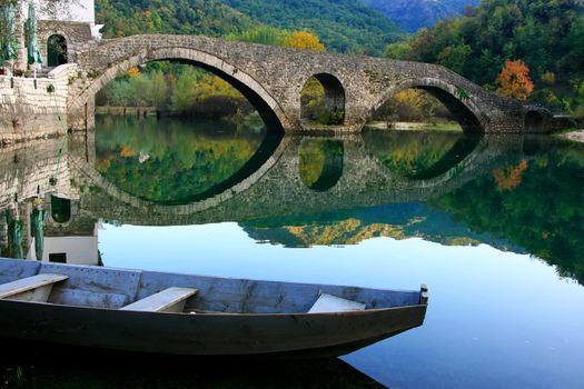 Arched bridge reflected in Crnojevica river, Montenegro, Balkans