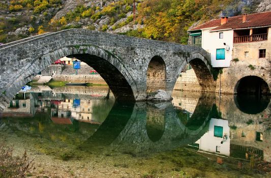 Arched bridge reflected in Crnojevica river, Montenegro, Balkans