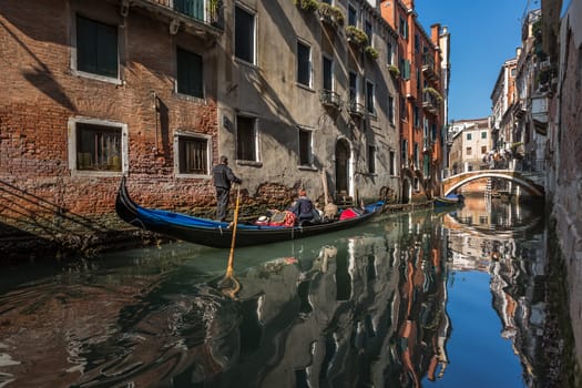 Traditional Venice Gandola Ride along Narrow Canal, Venice, Italy