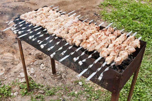 Russian grill. Brochettes on the grill. Pig meat