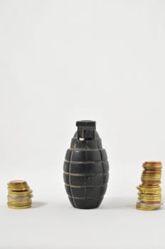 Money for War Concept Hand Grenade and coins